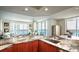 Stylish kitchen featuring marble countertops, stainless steel appliances, and an open layout with access to the living area at 231 Riverside Dr # 1602, Holly Hill, FL 32117