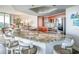 Modern kitchen showcasing a large island with marble countertop, updated appliances, and abundant storage space at 231 Riverside Dr # 1602, Holly Hill, FL 32117