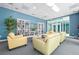 Comfortable lounge area with plush seating, bookshelves, and a TV for relaxing and socializing at 231 Riverside Dr # 1602, Holly Hill, FL 32117
