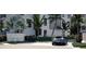A modern community entrance sign with landscaping, gray car, and contemporary architecture at 2360 Ocean Shore Blvd # 10, Ormond Beach, FL 32176