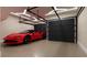 Sleek garage with polished concrete floors, modern lighting, and a red sports car at 2360 Ocean Shore Blvd # 10, Ormond Beach, FL 32176