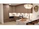 Stylish kitchen features wood cabinets, marble countertops, and modern lighting, creating a warm and inviting space at 2360 Ocean Shore Blvd # 10, Ormond Beach, FL 32176