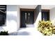 Contemporary front entrance with a stylish door, accented by sleek wood panels and lush greenery for added curb appeal at 2360 Ocean Shore Blvd # 11, Ormond Beach, FL 32176
