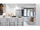 Modern kitchen with white cabinetry, stainless steel appliances, and an open layout into the dining area at 2360 Ocean Shore Blvd # 12, Ormond Beach, FL 32176