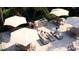 Inviting outdoor patio area with tables, umbrellas, modern seating, and a built-in grill for social gatherings at 2360 Ocean Shore Blvd # 12, Ormond Beach, FL 32176