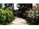 A landscaped walkway features pavers, garden beds and leads to a secluded sitting area at 2360 Ocean Shore Blvd # 17, Ormond Beach, FL 32176