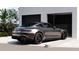 Sleek car parked in front of a modern garage with a well-manicured lawn, showcasing luxury living at 2360 Ocean Shore Blvd # 24, Ormond Beach, FL 32176