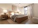 Cozy bedroom with a wooden platform bed, neutral color scheme, and large window with sheer curtains at 2360 Ocean Shore Blvd # 4, Ormond Beach, FL 32176