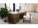 Bright home office space with a stylish desk, comfortable chair, and natural light from a large window at 2360 Ocean Shore Blvd # 4, Ormond Beach, FL 32176
