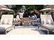Outdoor gathering area with lounge chairs, umbrellas, and built-in BBQ, perfect for entertaining at 2360 Ocean Shore Blvd # 4, Ormond Beach, FL 32176