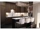 Modern kitchen with sleek cabinets, marble backsplash, and a stylish island with seating at 2360 Ocean Shore Blvd # 7, Ormond Beach, FL 32176