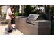 Well-equipped outdoor kitchen with a built-in grill and countertop, creating a perfect space for alfresco dining and entertainment at 2360 Ocean Shore Blvd # 7, Ormond Beach, FL 32176