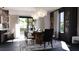 Elegant dining area with unique lighting, a statement table, and bright natural light from the sliding glass door at 2360 Ocean Shore Blvd # 8, Ormond Beach, FL 32176