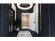 Elegant foyer with modern chandelier, black accents, and stylish white doors for a sophisticated entrance at 2360 Ocean Shore Blvd # 8, Ormond Beach, FL 32176