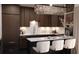 Modern kitchen with dark wood cabinetry, marble countertops, and elegant pendant lighting at 2360 Ocean Shore Blvd # 8, Ormond Beach, FL 32176