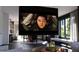 Cozy living room with a large projector screen, stylish decor, and open access to the dining area at 2360 Ocean Shore Blvd # 8, Ormond Beach, FL 32176