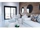 Living room featuring modern decor, including two round mirrors, and outdoor balcony access at 2360 Ocean Shore Blvd # 9, Ormond Beach, FL 32176