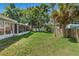 Wide backyard with well-kept lawn and a screened porch, providing privacy and relaxation at 2531 Needle Palm Dr, Edgewater, FL 32141