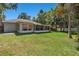 Expansive backyard with lush green grass and a screened patio, perfect for outdoor enjoyment at 2531 Needle Palm Dr, Edgewater, FL 32141