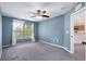 Bedroom with a ceiling fan, large window and light blue paint at 2531 Needle Palm Dr, Edgewater, FL 32141