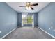 Bedroom featuring a large window with natural light and neutral-colored carpet at 2531 Needle Palm Dr, Edgewater, FL 32141