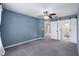 Carpeted bedroom with a ceiling fan, ensuite bathroom and walk in closet at 2531 Needle Palm Dr, Edgewater, FL 32141