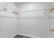 A bright walk-in closet featuring installed white wire shelving and a neutral color palette at 2531 Needle Palm Dr, Edgewater, FL 32141