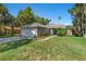 Inviting single-story home showcasing a two-car garage, lush lawn, and inviting front entryway at 2531 Needle Palm Dr, Edgewater, FL 32141