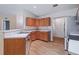 Well-lit kitchen with tile floors, wooden cabinetry, and stainless steel appliances at 2531 Needle Palm Dr, Edgewater, FL 32141