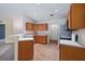 Bright kitchen featuring tile floors, wood cabinets and stainless steel appliances at 2531 Needle Palm Dr, Edgewater, FL 32141