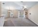 Open-concept living room featuring neutral paint, carpet flooring, and sliding glass doors at 2531 Needle Palm Dr, Edgewater, FL 32141