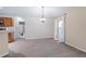 Neutral living area with dining space, carpet, and nearby bathroom and kitchen at 2531 Needle Palm Dr, Edgewater, FL 32141