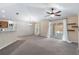 Spacious living room boasts neutral paint, carpet flooring, a ceiling fan, and slider door at 2531 Needle Palm Dr, Edgewater, FL 32141