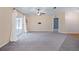 Large living room featuring slider door to porch, neutral colors, ceiling fan, and carpet floors at 2531 Needle Palm Dr, Edgewater, FL 32141