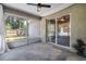 View of the screened porch with concrete flooring, ceiling fan, and sliding glass doors to the outside at 2531 Needle Palm Dr, Edgewater, FL 32141