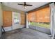 Enclosed sunroom with bamboo blinds, sheer curtains, and concrete flooring at 2531 Needle Palm Dr, Edgewater, FL 32141