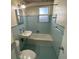 Cozy bathroom featuring a bathtub, window, and a sink at 264 Sherwood Ln, Daytona Beach, FL 32117