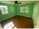 Bright bedroom with hardwood floors, a ceiling fan and view of backyard at 264 Sherwood Ln, Daytona Beach, FL 32117