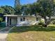 Charming single-story home featuring a well-maintained front yard with mature trees at 264 Sherwood Ln, Daytona Beach, FL 32117
