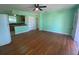 Inviting living room featuring gleaming hardwood floors, ceiling fan, and abundant natural light at 264 Sherwood Ln, Daytona Beach, FL 32117