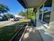 View from the porch showing the neighborhood street and a glimpse of the front yard and mature trees at 264 Sherwood Ln, Daytona Beach, FL 32117