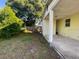 Spacious side yard with a view of the carport and a well-defined property line with a wooden fence at 264 Sherwood Ln, Daytona Beach, FL 32117