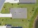 Aerial view showcases the home's roof, driveway, and surrounding landscaping including small trees and green grass at 2836 Monaghan Dr, Ormond Beach, FL 32174