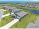 Aerial view of a modern home with lush landscaping and a pond in a Primary planned community at 2836 Monaghan Dr, Ormond Beach, FL 32174