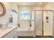 Well-lit bathroom with a tub and separate shower, complemented by elegant fixtures and finishes at 2836 Monaghan Dr, Ormond Beach, FL 32174
