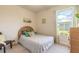 Sunlit bedroom features a bed, large window and home decor at 2836 Monaghan Dr, Ormond Beach, FL 32174
