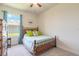 Cozy bedroom with bed, dresser, and bright window at 2836 Monaghan Dr, Ormond Beach, FL 32174