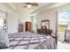 Bright bedroom with tray ceilings, natural light, and classic wooden furniture at 2836 Monaghan Dr, Ormond Beach, FL 32174