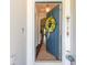 Welcoming entryway featuring an open door adorned with a wreath and glimpses of the home's interior at 2836 Monaghan Dr, Ormond Beach, FL 32174