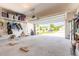 A spacious garage with visible storage shelves and a garage door open to a sunny driveway at 2836 Monaghan Dr, Ormond Beach, FL 32174